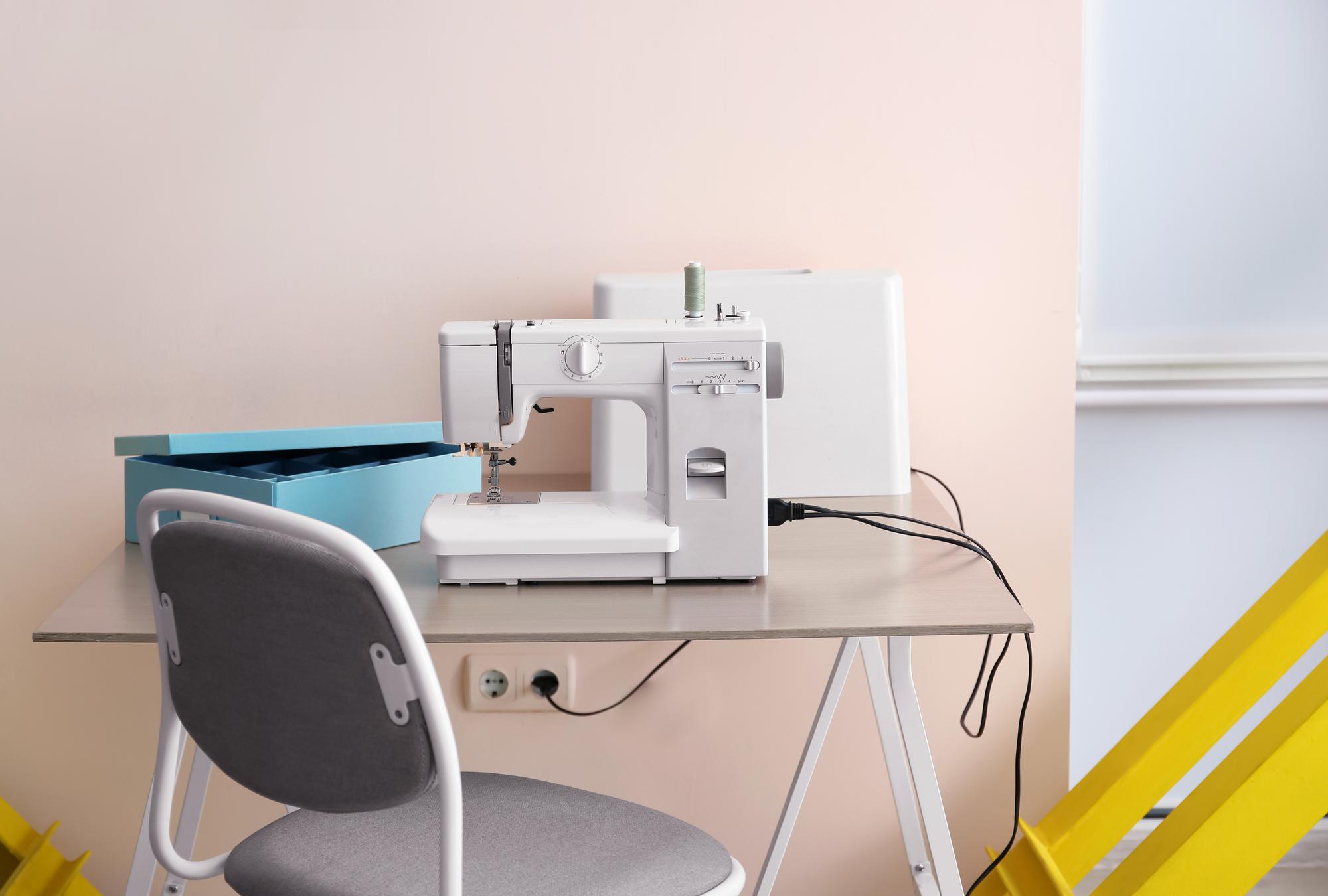 Studio workspace with embroidery machine and monitor